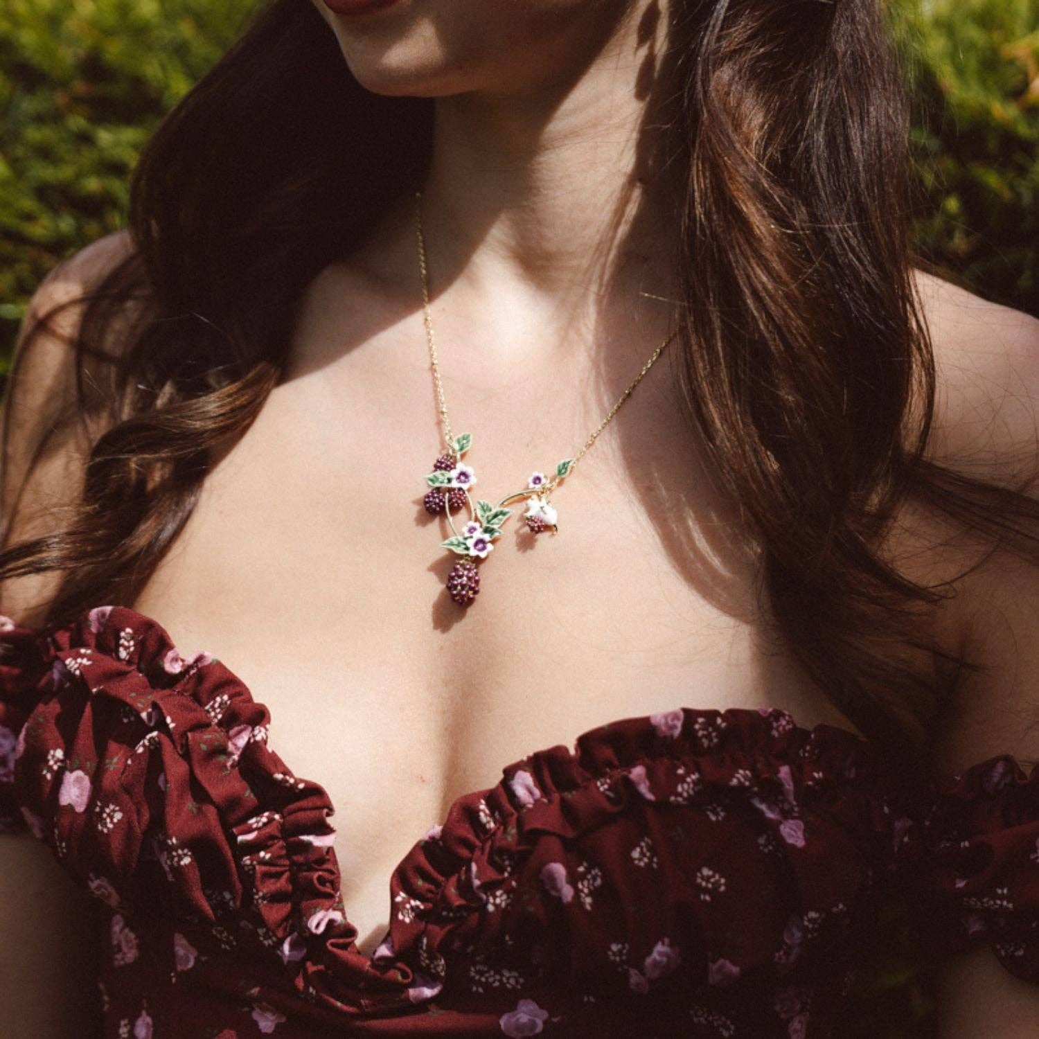 Blackberry Mouse Necklace by Bill Skinner Studio worn by a model, showcasing its intricate design and vibrant colors.