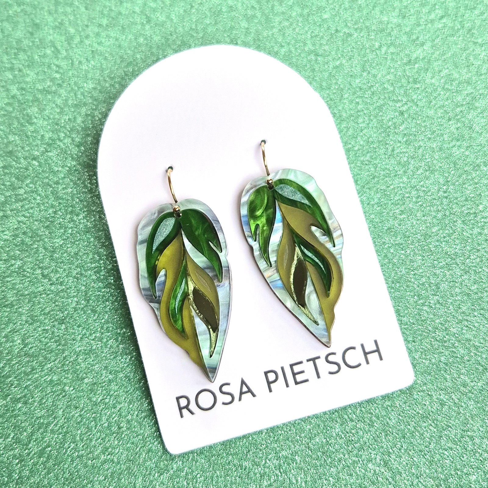 Handmade Calathea leaf earrings by Rosa Pietsch featuring green marbled acrylic and gold-filled hooks.