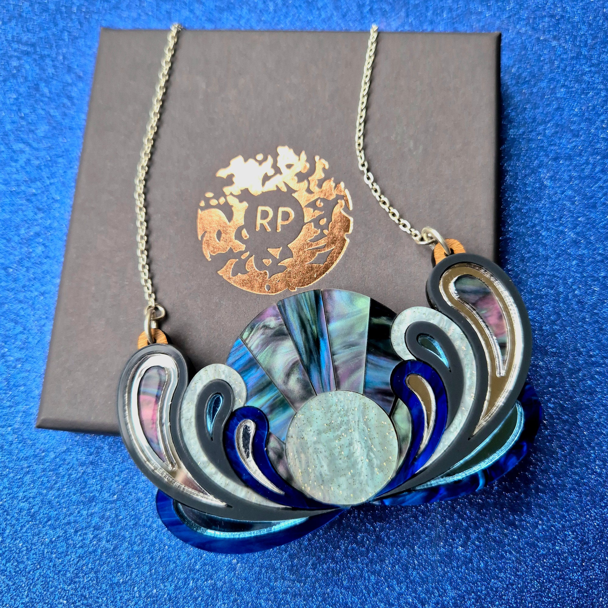 Psychedelic Sunrise Bib Necklace by Rosa Pietsch, featuring layered acrylic in vibrant lunar colours and a silver chain.