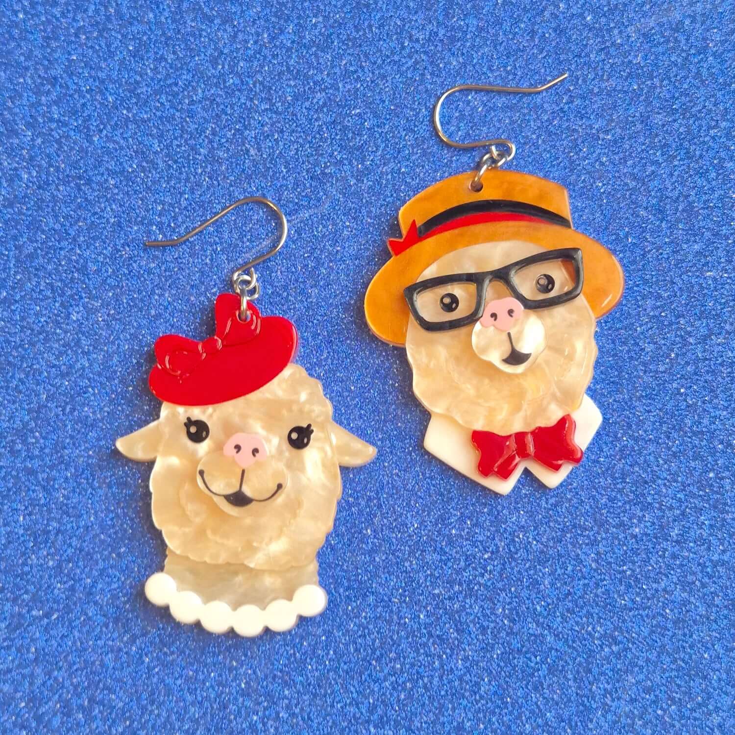 Erstwilder Enamoured Alpacas drop earrings featuring stylish alpacas in hats and glasses on a blue background.